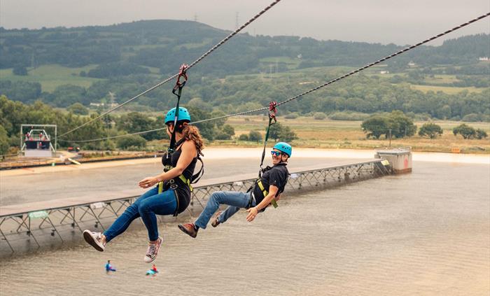 Zip over the heads of surfers on a tandem ride